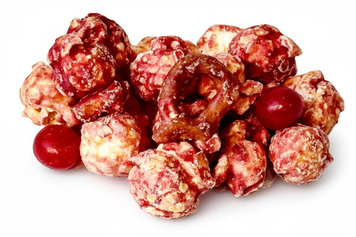 A pile of bunny pop white chocolate caramel popcorn with raspberries pretzels and savory flavors in red and white