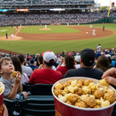 People enjoying popcorn at a baseball game in a stadium