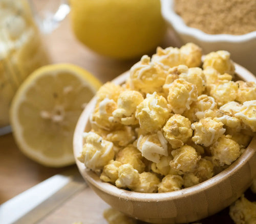 A bowl of fluffy, yellow-tinted popcorn, possibly flavored with lemon or butter.