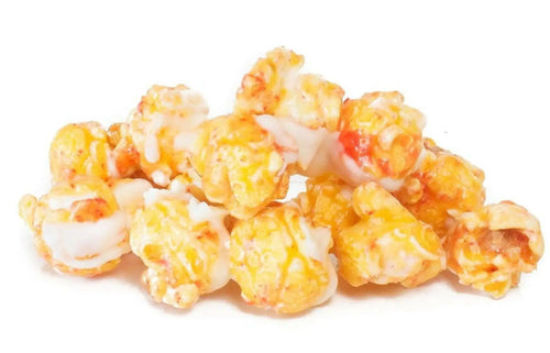 A pile of caramel and white chocolate drizzled popcorn.