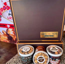 Chocolate popcorn tin box with gold accents and ’love pops’ branding.