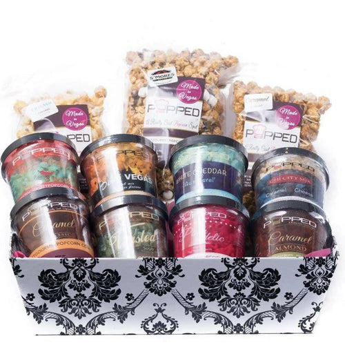 A gift basket filled with various flavors of gourmet popcorn.