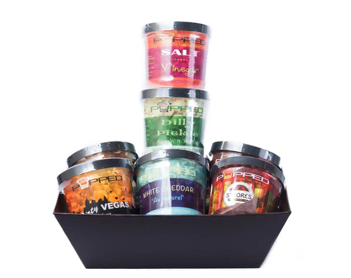 A collection of gourmet popcorn seasonings in clear plastic containers.