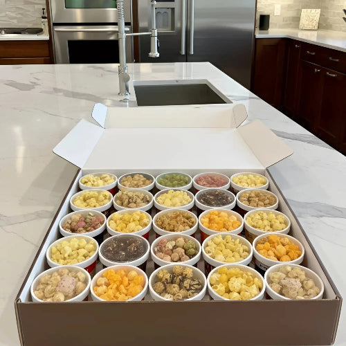 Popcorn box filled with various flavors and colors, including classic yellow kernels and unique gourmet options.