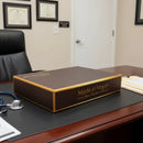 A rectangular dark brown box with golden accents, likely for food, with ’Made in Vegas’ and ’Every Bite Hits the Jackpot!’ printed on its side.