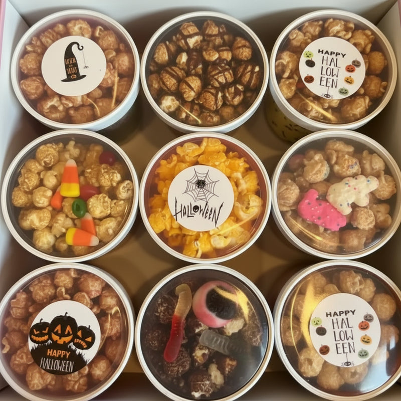 A box of nine Halloween-themed popcorn and candy treats.