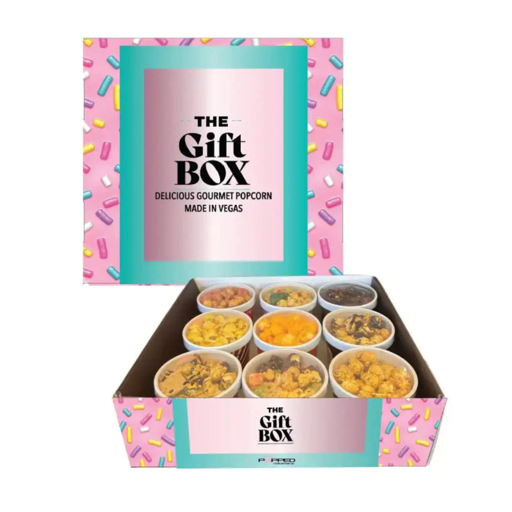An open gift box containing nine small containers of gourmet popcorn.