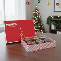 Red and white striped holiday popcorn gift set box with a christmas tree design.