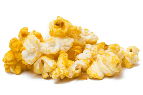 A pile of seasoned popcorn with a white and yellow hue.