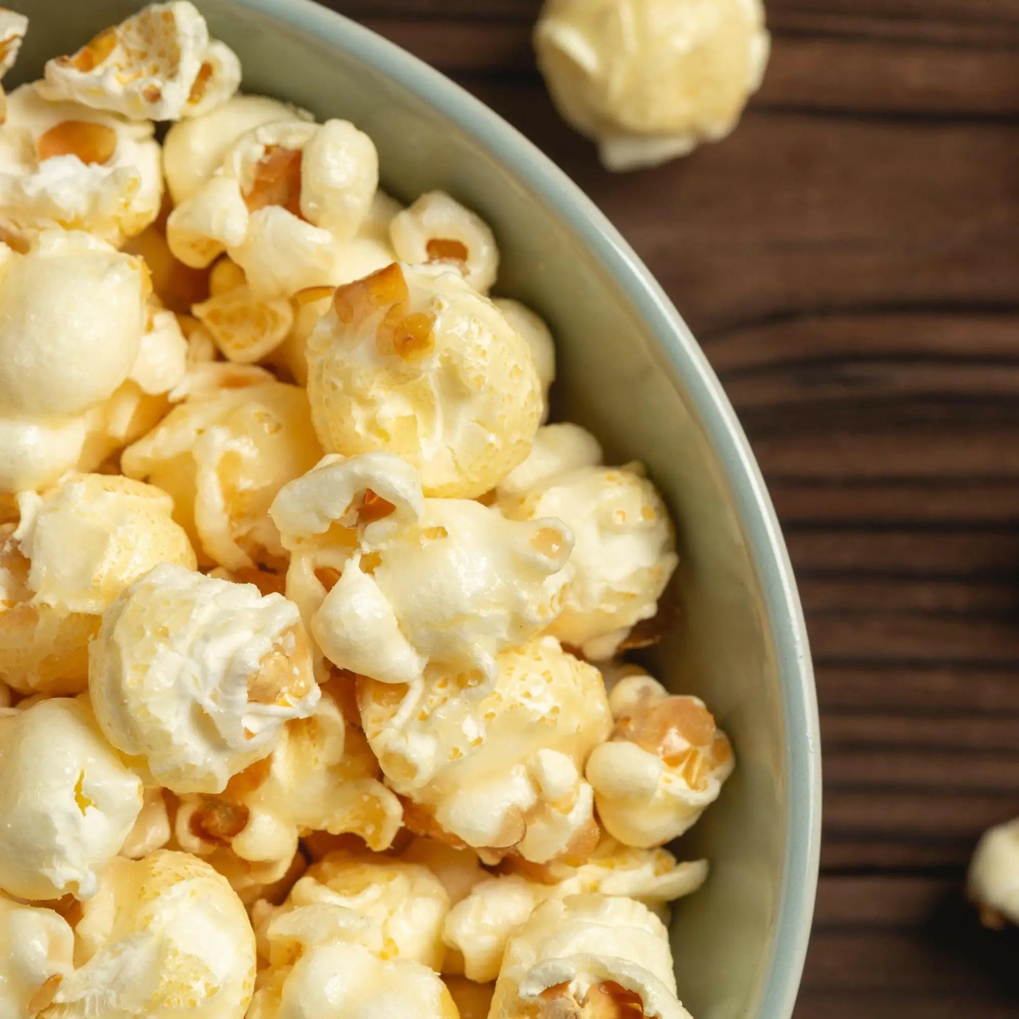 A bowl of fluffy, buttered popcorn.