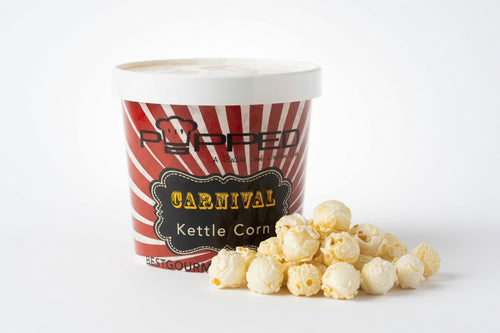 A tub of Popped' Popcorn 'Carnival Kettle Corn' next to a small pile of popped popcorn on a clean white background.