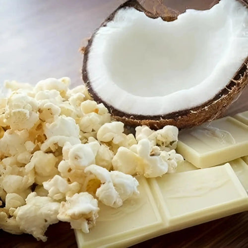 A half coconut, white chocolate bars, and popcorn.