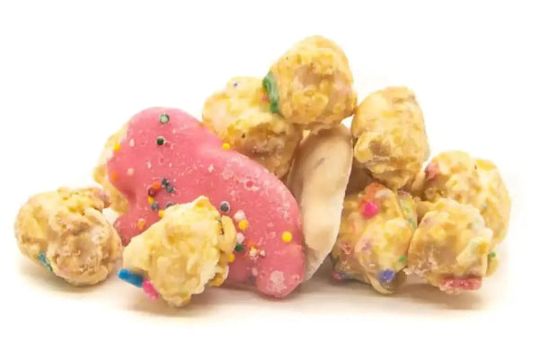 A pile of pink-frosted animal crackers with sprinkles and caramel popcorn.