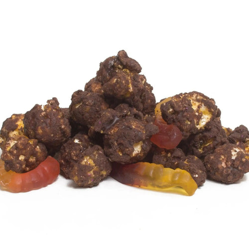 Chocolate-covered popcorn with gummy worms and candies