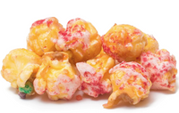 Colorful popcorn with raspberries toppings on a white background