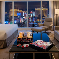 Luxury hotel room with cityscape view, and popped las vegas popcorn gift basket on the table items.