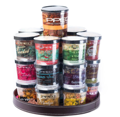 A tiered display of gourmet popcorn tubs in various flavors.