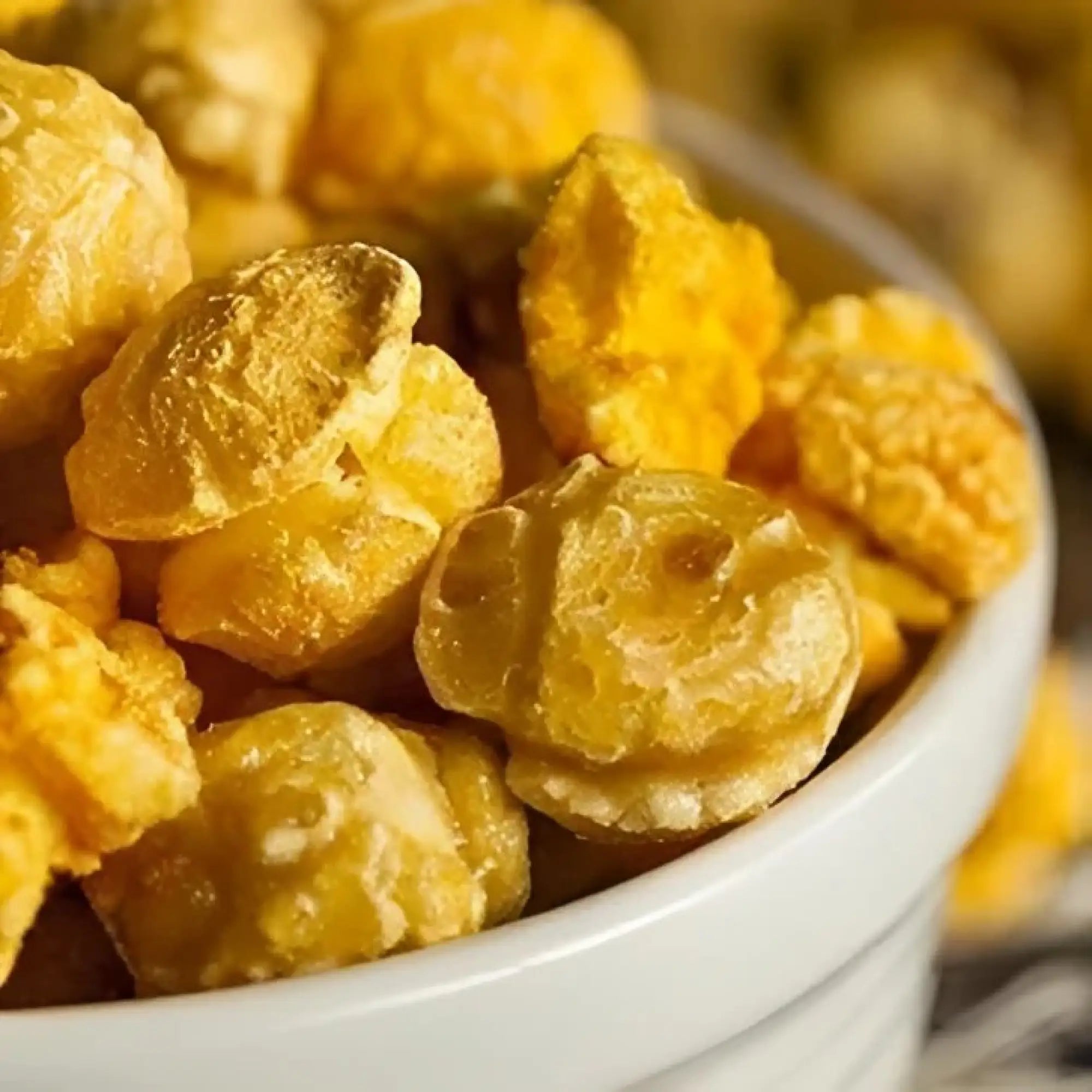 A bowl of fluffy, golden-yellow cheese popcorn.